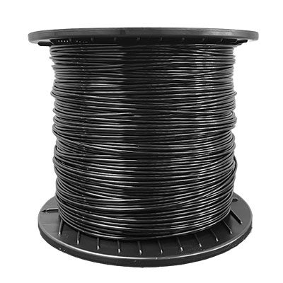 A spool of black wire sitting on top of a white table.